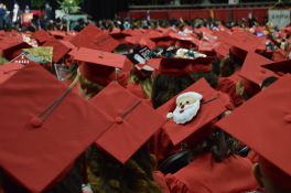 Various red graduation mortarboards at graduation Various red graduation mortarboards at graduation